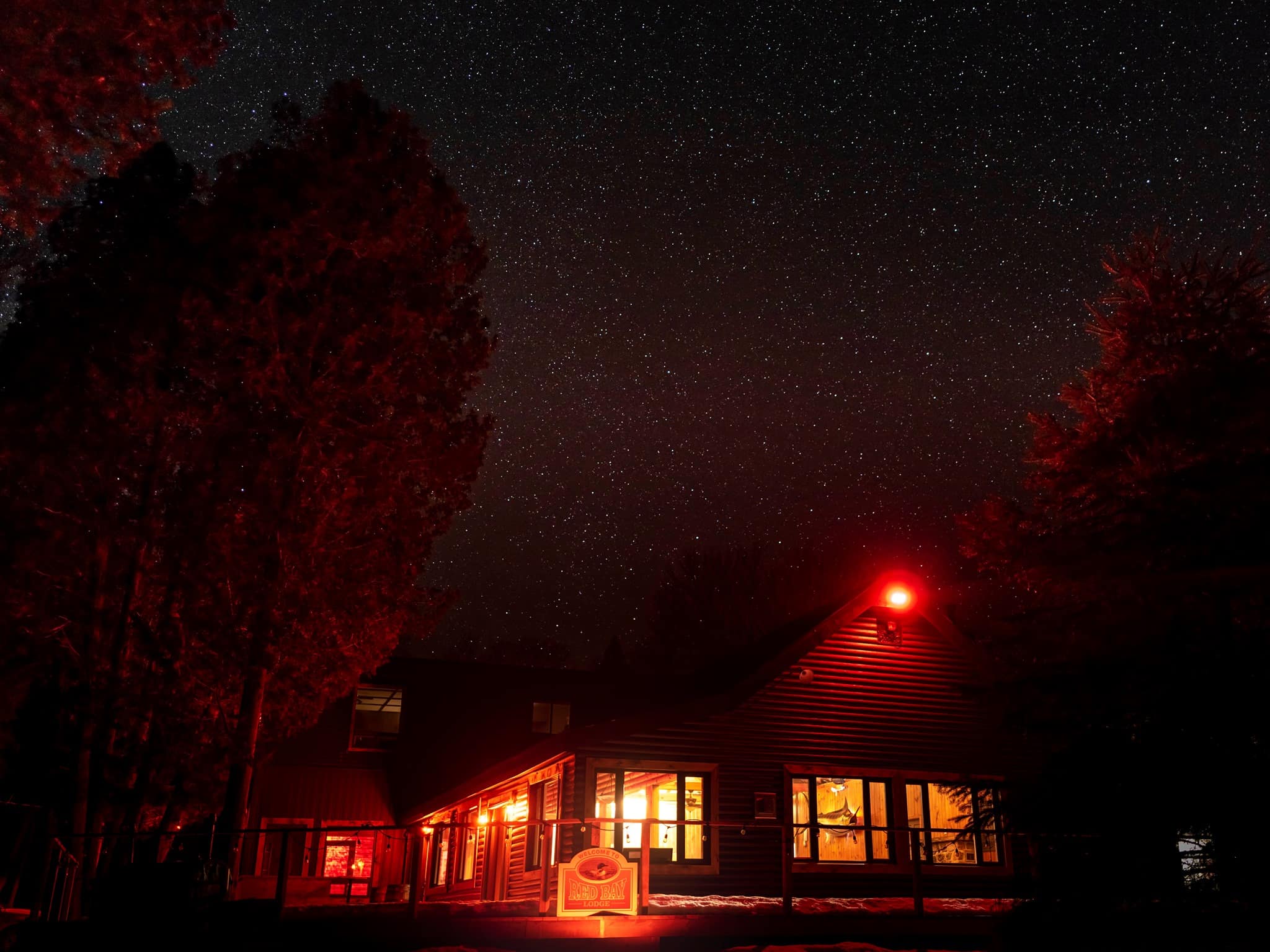 The lodge at night under a sky full of stars