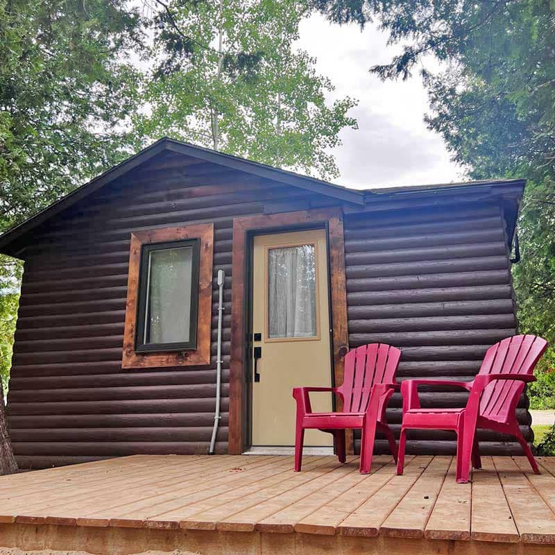 A cabin exterior at Red Bay Lodge, chairs out front