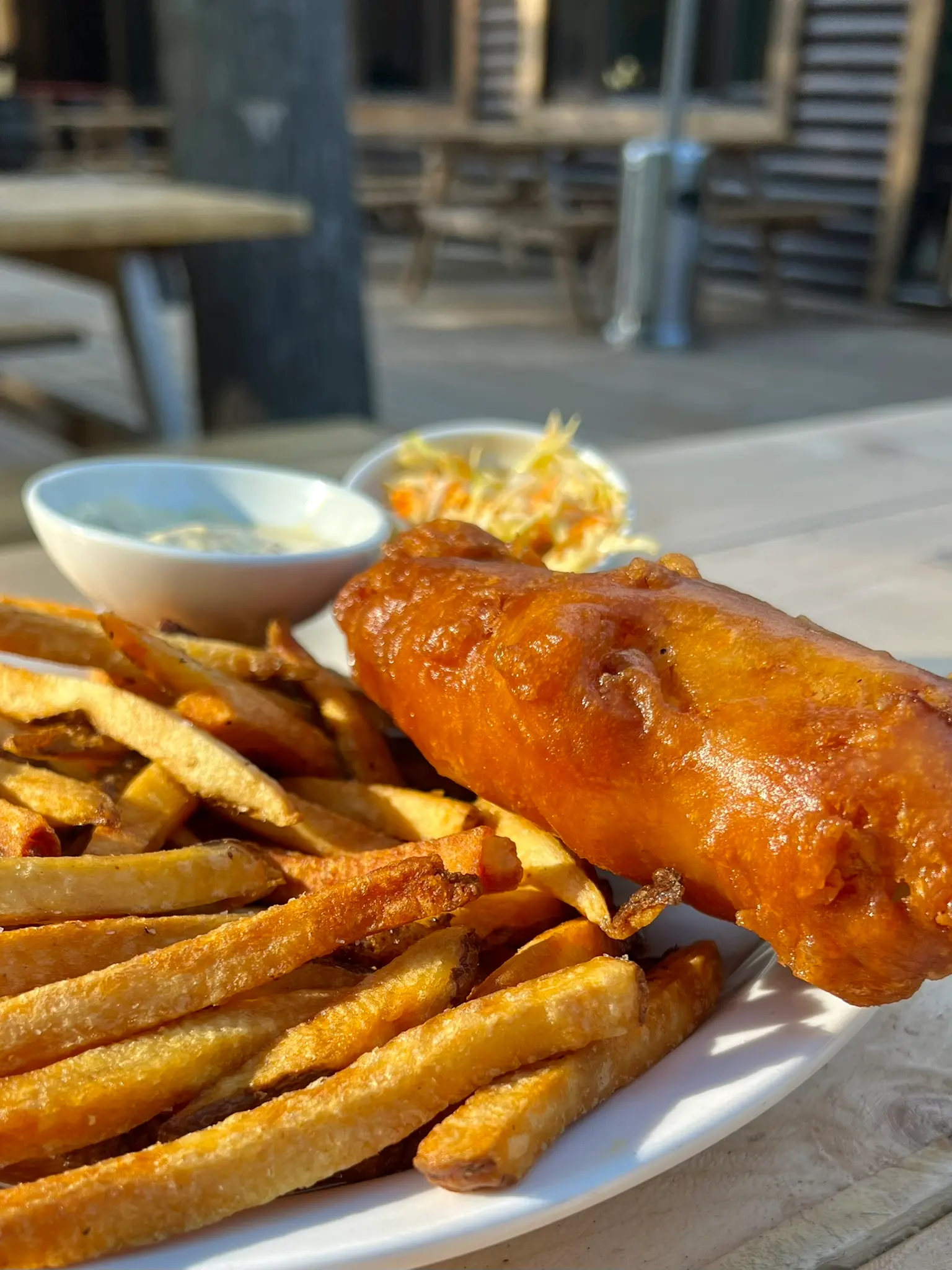 Battered fish and hand-cut chips on the patio of the dining lodge
