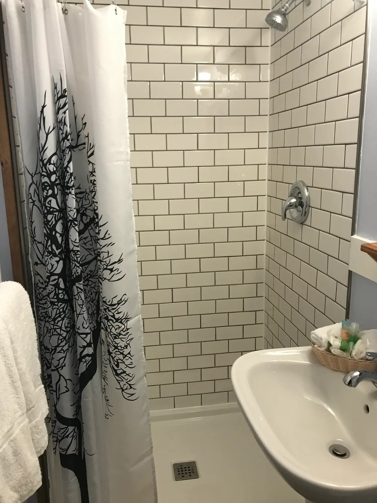 Tiled shower and sink in the private bathroom of the Ash, a 1 bedroom cabin