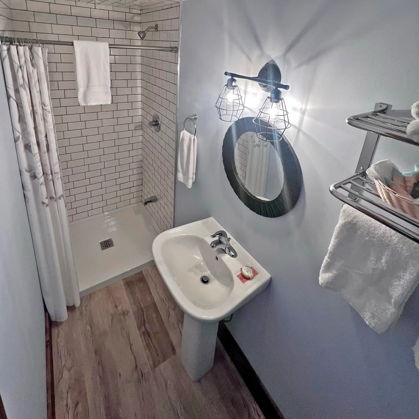 Tiled shower, sink and mirror in the private bathroom of the Tamarack