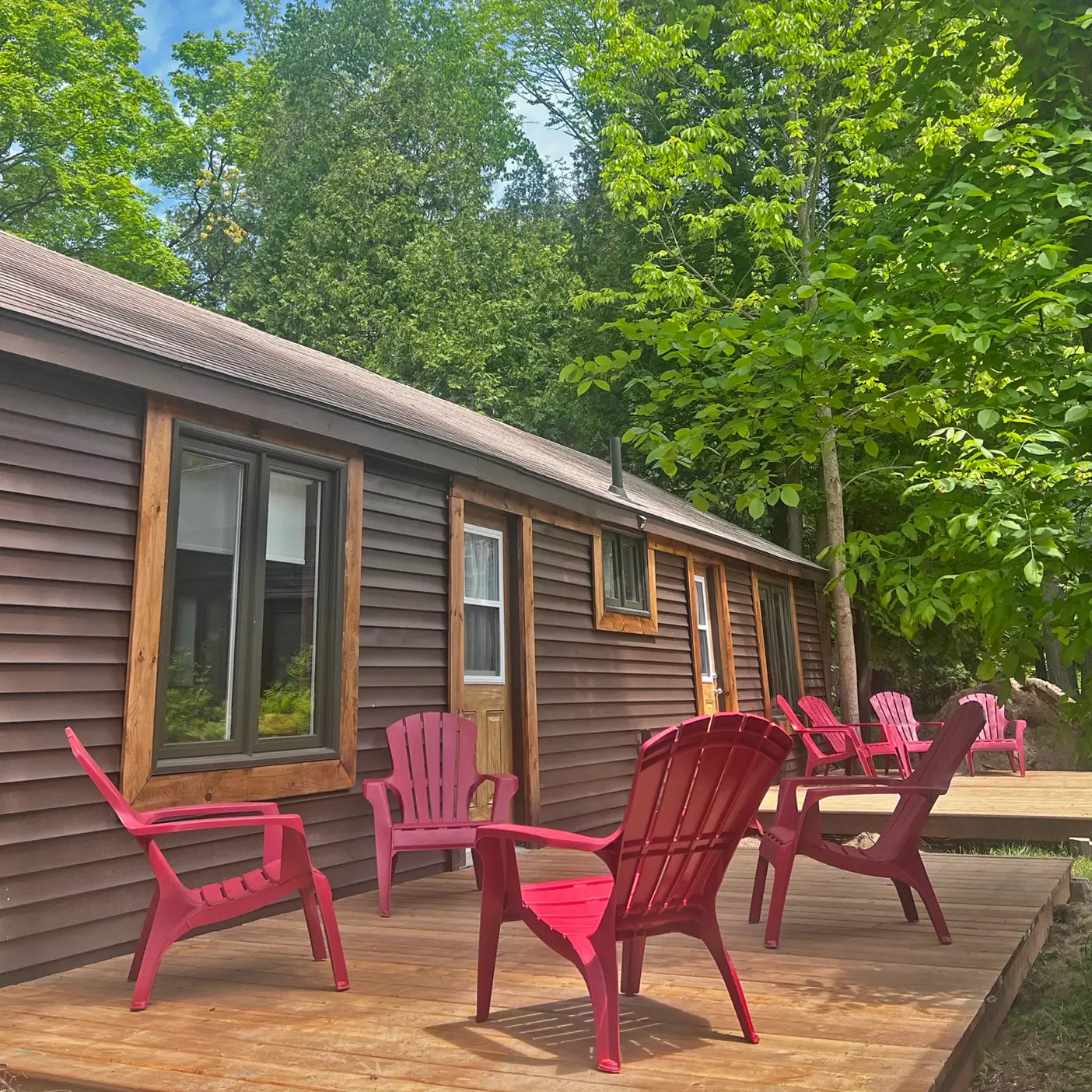 The Red Cedar, one of our largest cabins, with a long deck and red chairs