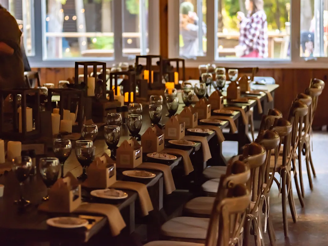 A long table set with candles and glassware for a group dinner at Red Bay Lodge